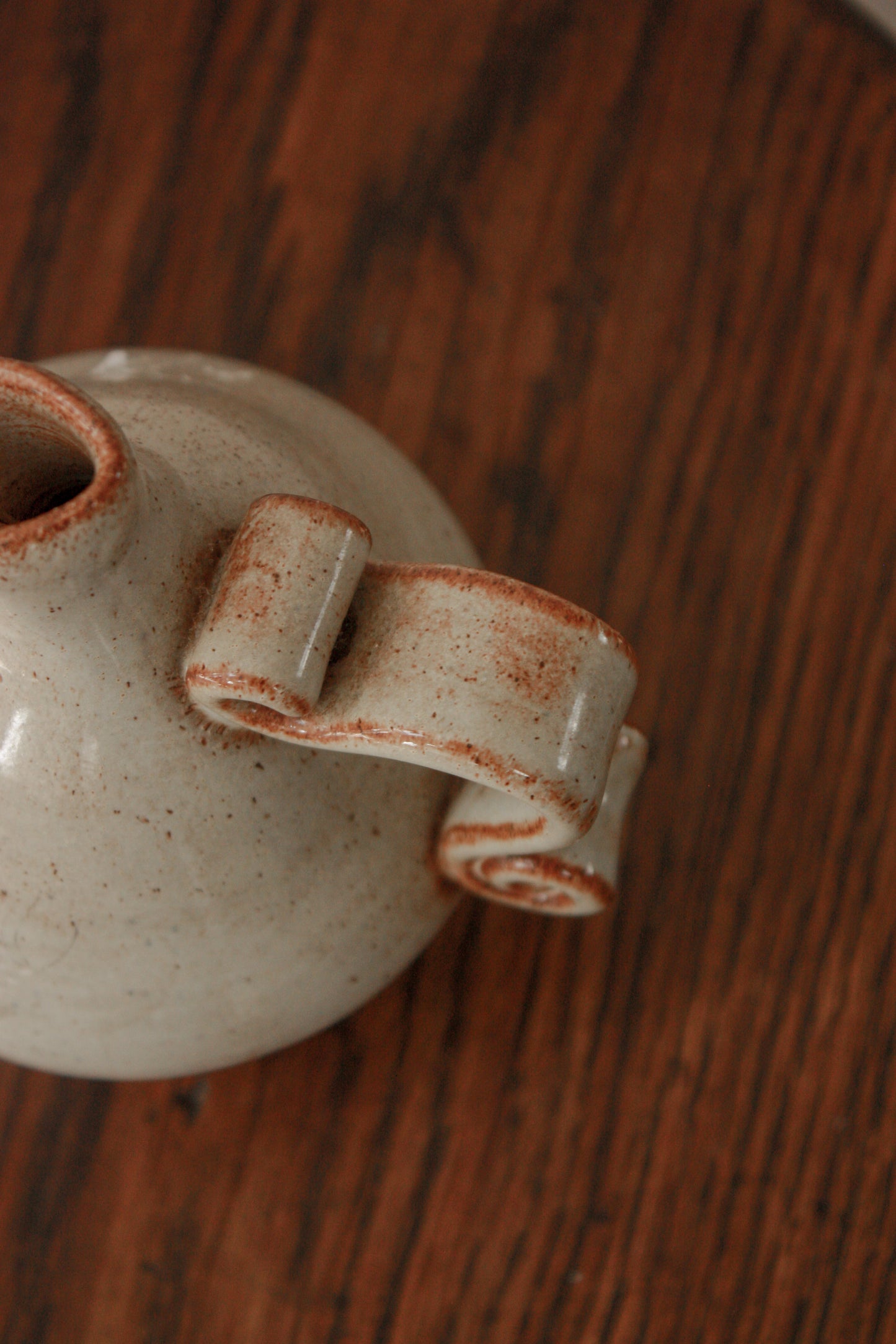 Studio pottery bud vase with scroll handle