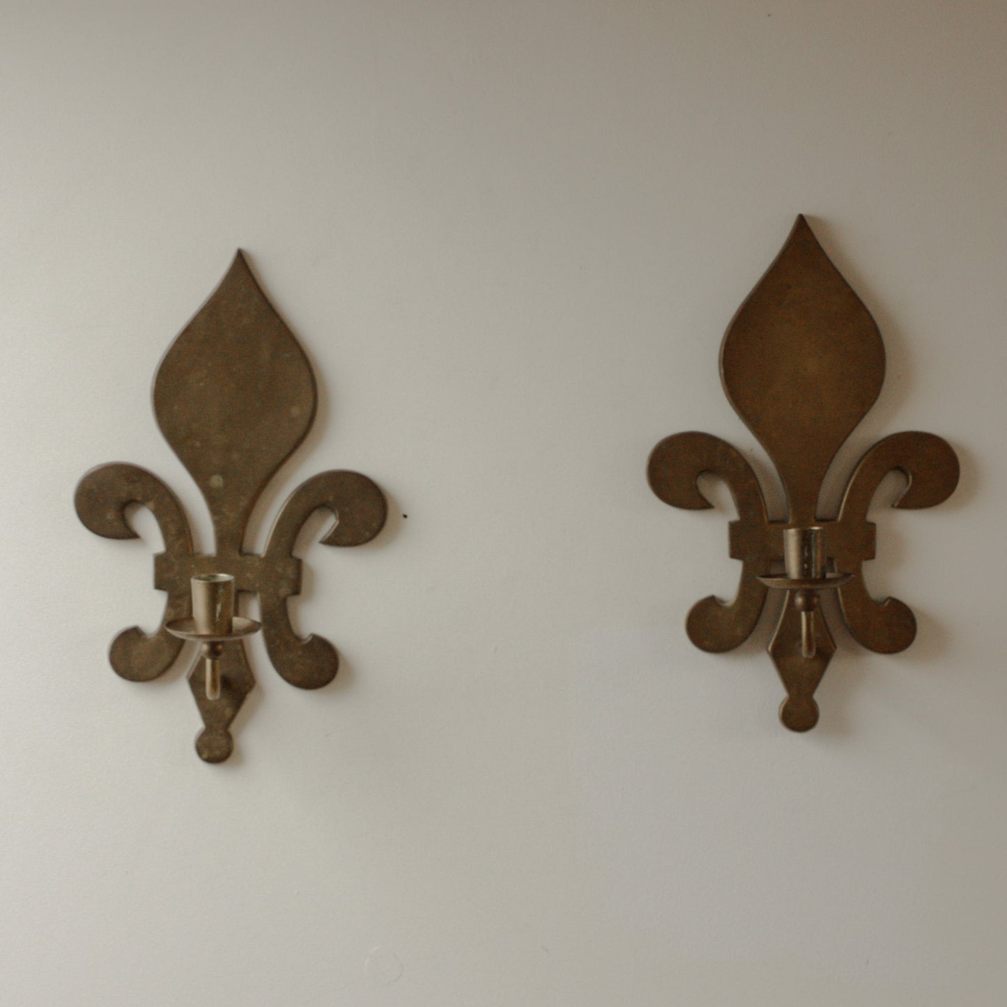 Large pair of antique brass fleur de lis candle sconces