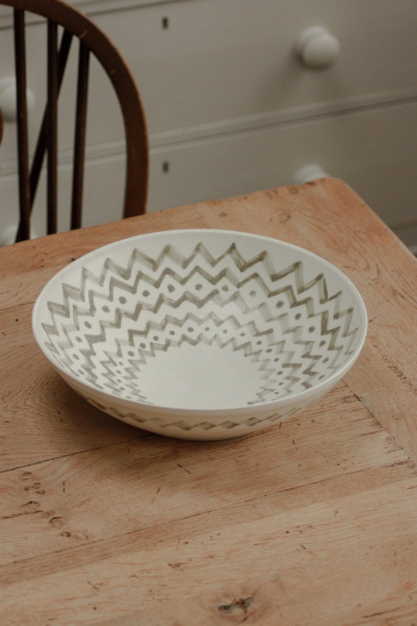 Large studio pottery serving bowl with muted green design