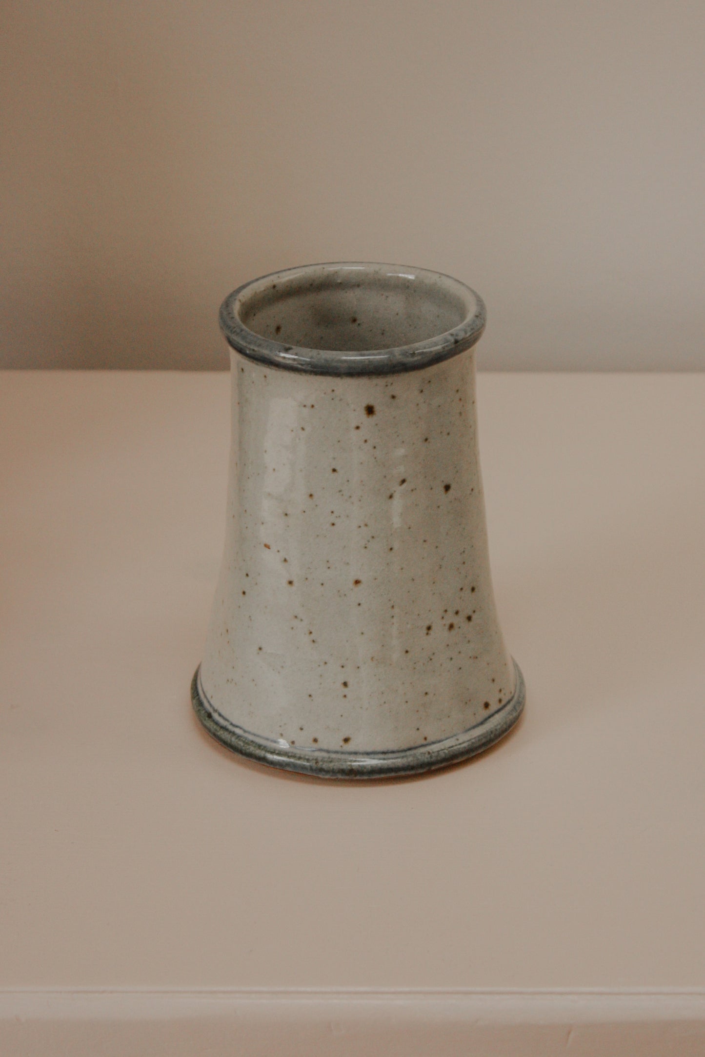 Rustic studio pottery vase with blue foliage details