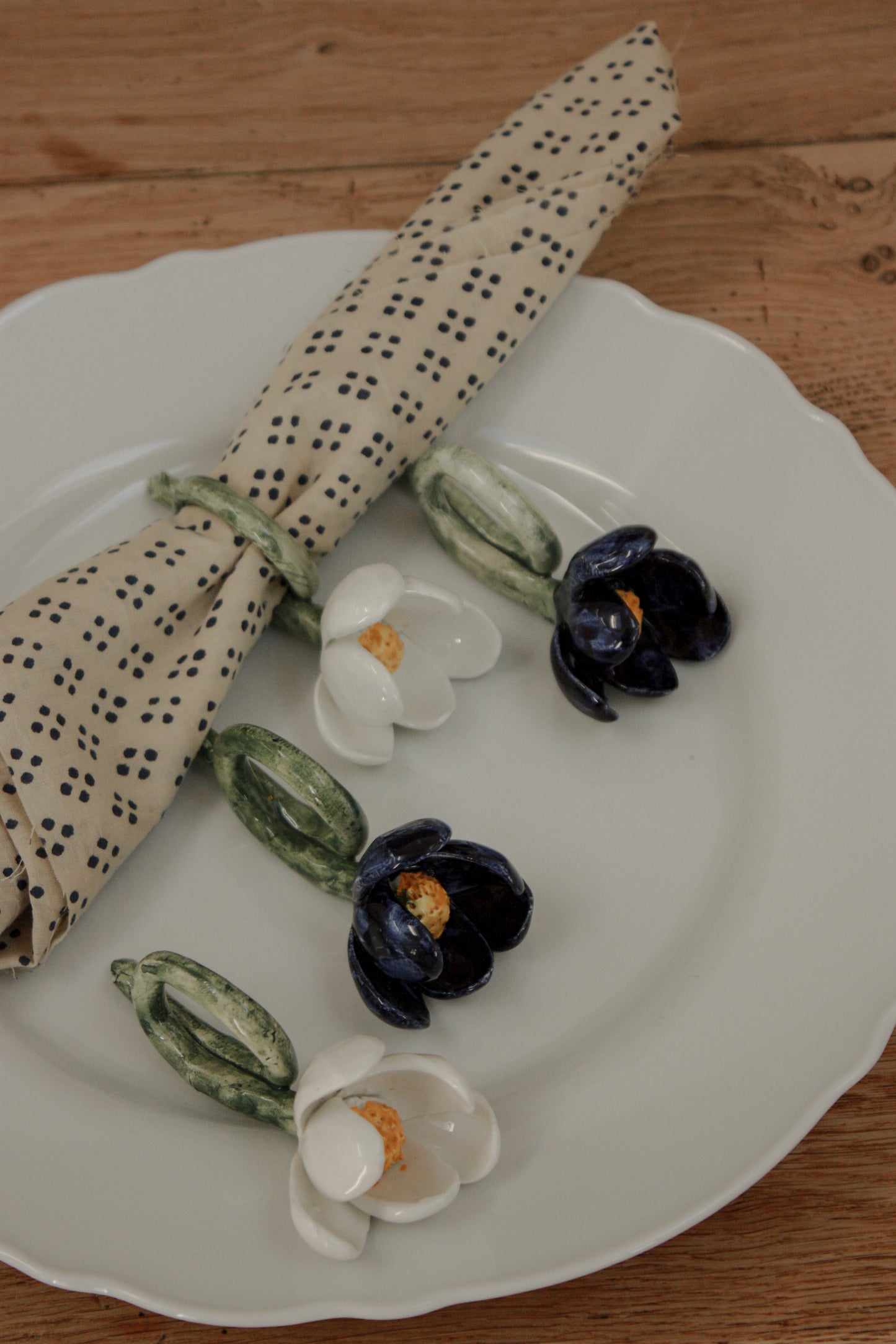Set of four folk art pottery flower napkin rings