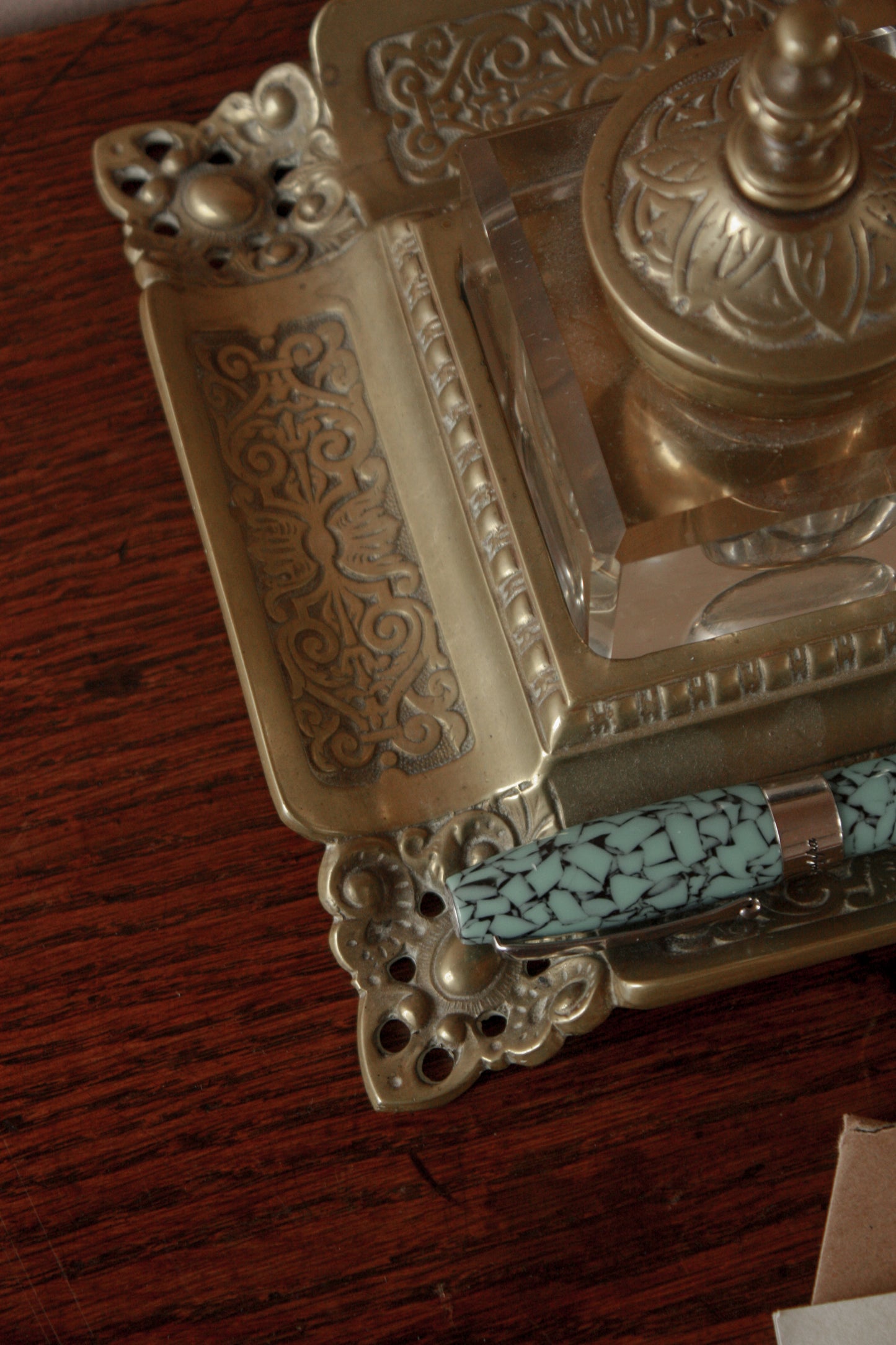 Antique ornate brass ink well with glass ink bottle