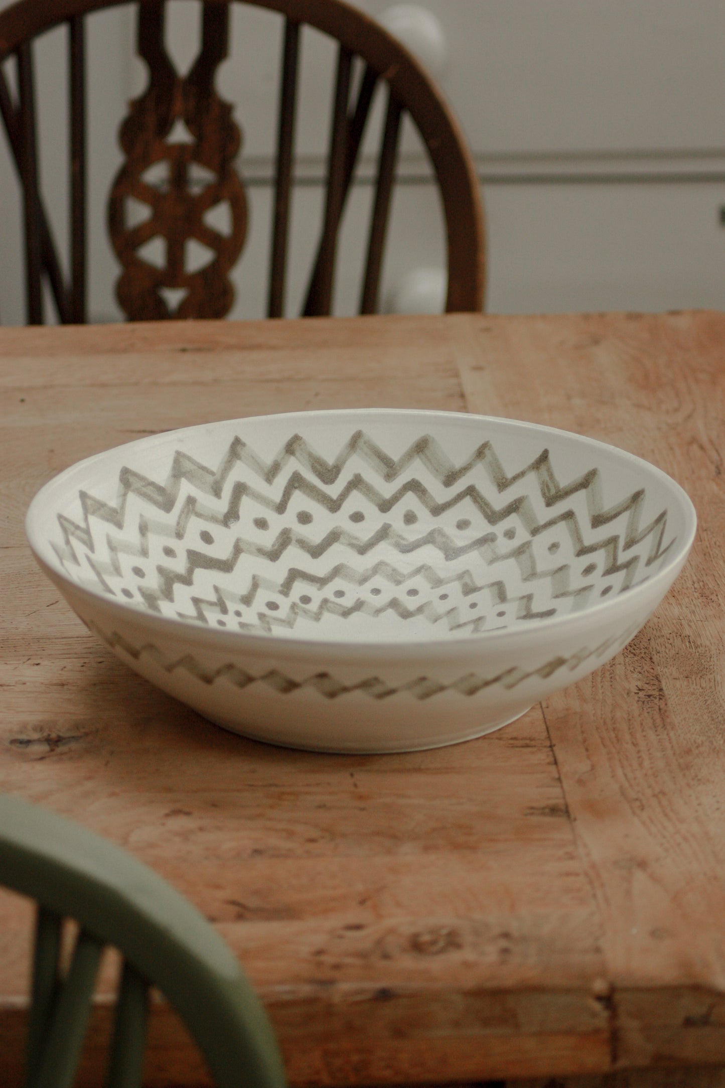 Large studio pottery serving bowl with muted green design