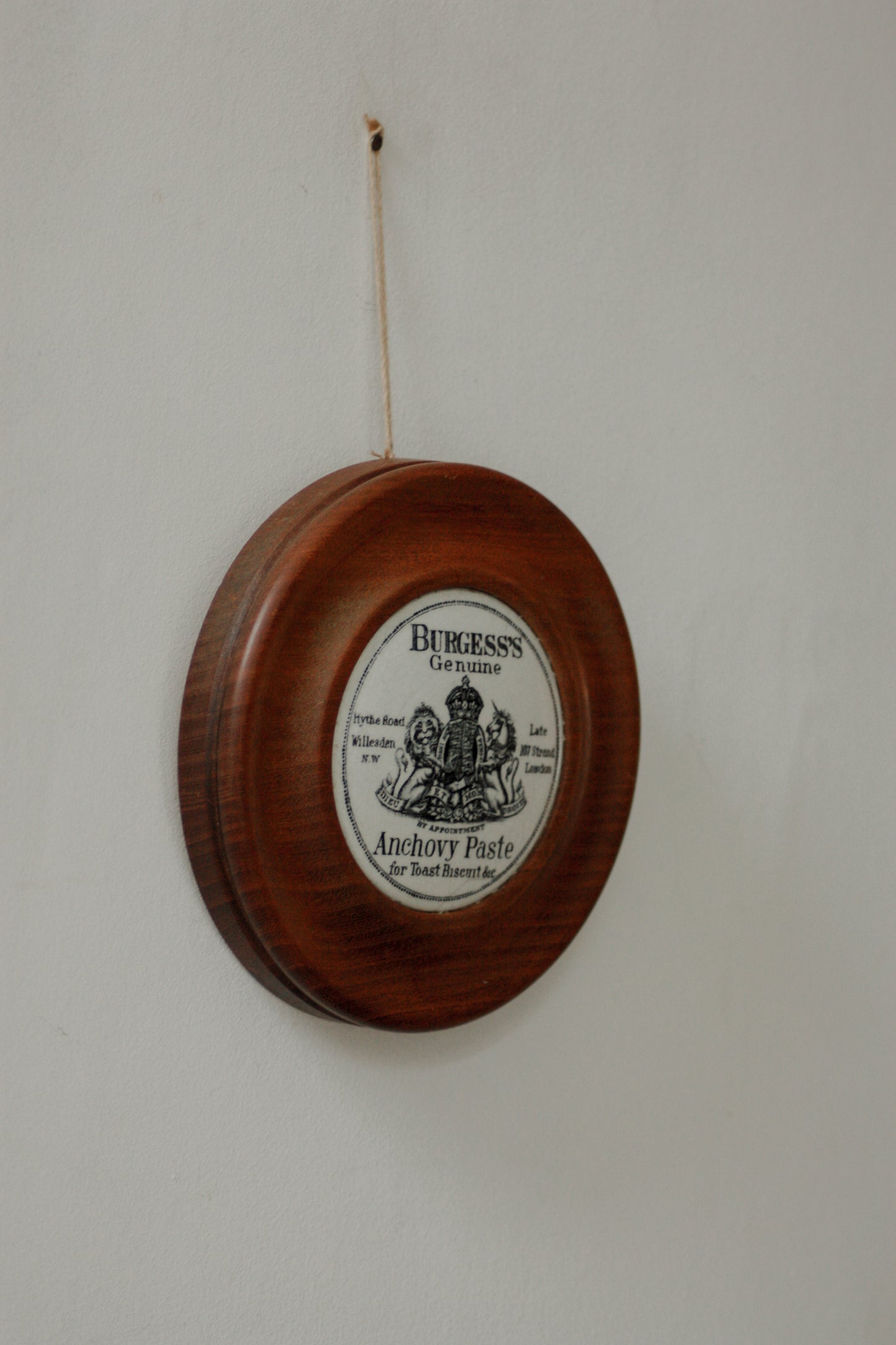 Vintage paste pot lid set in wooden frame