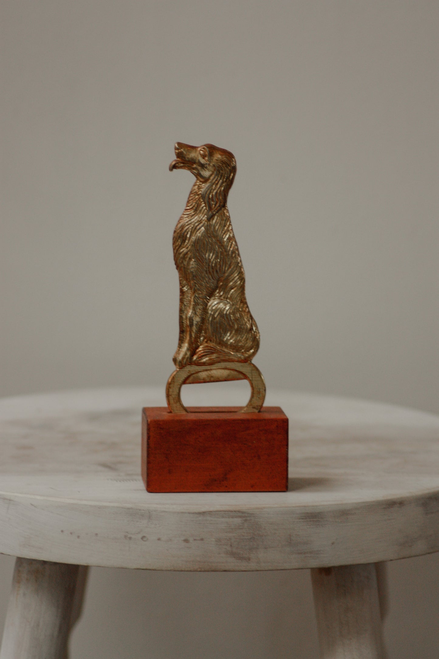 Vintage brass plated dog bottle opener with stand