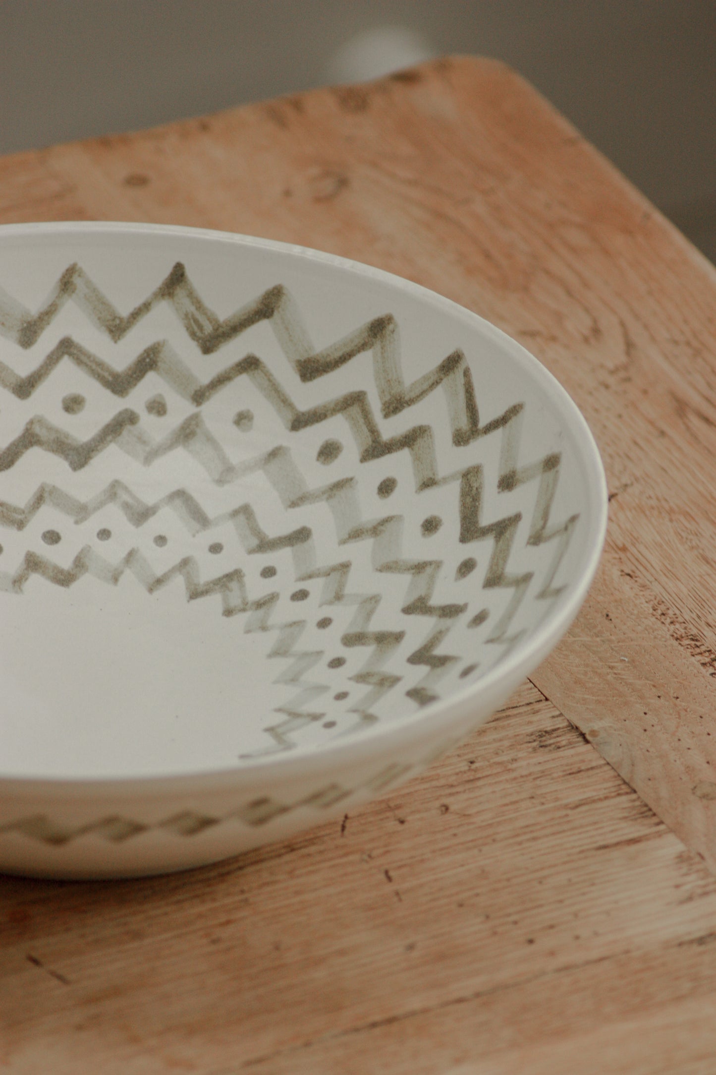 Large studio pottery serving bowl with muted green design