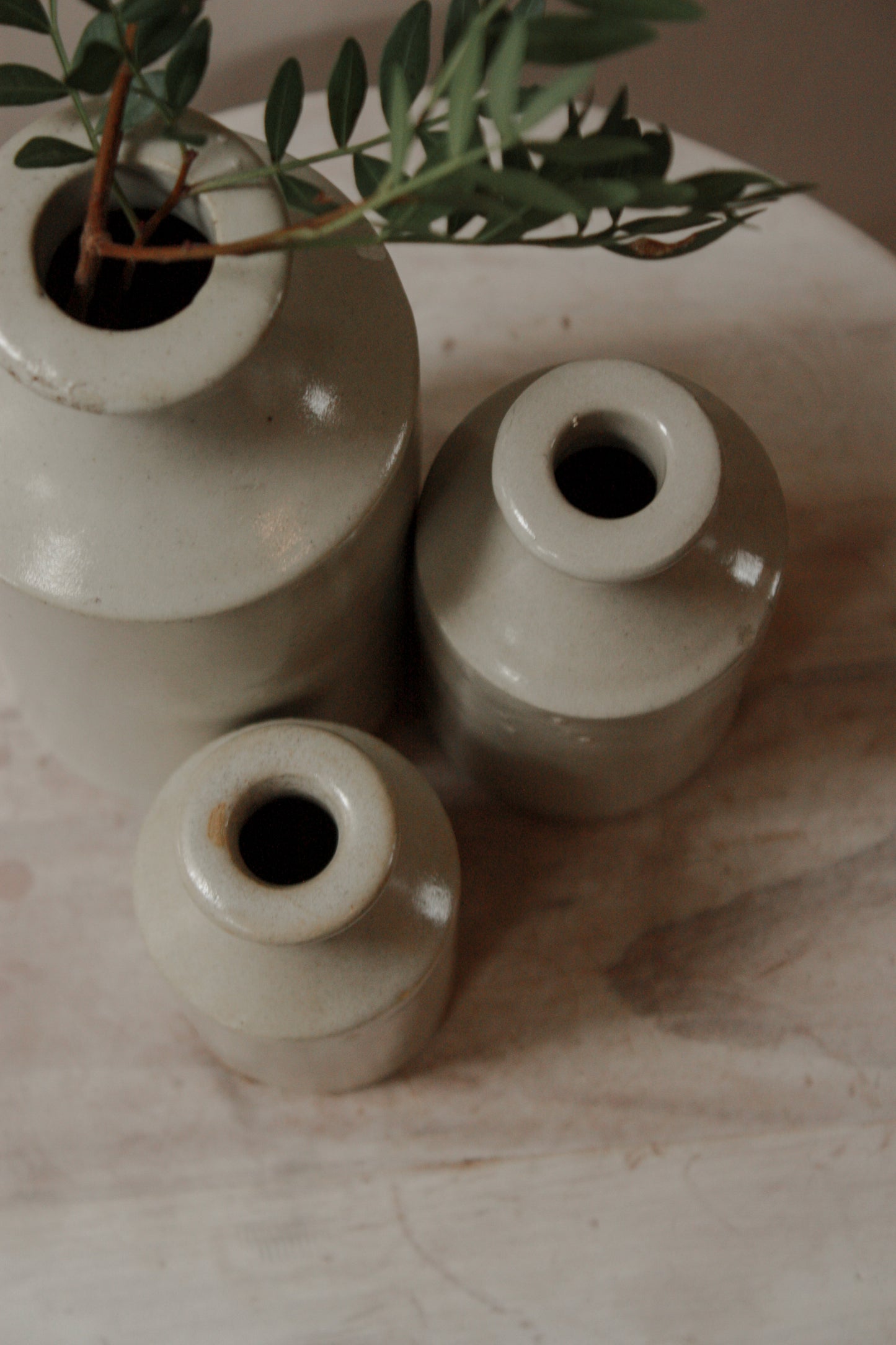 Vintage set of three pale stoneware bottles