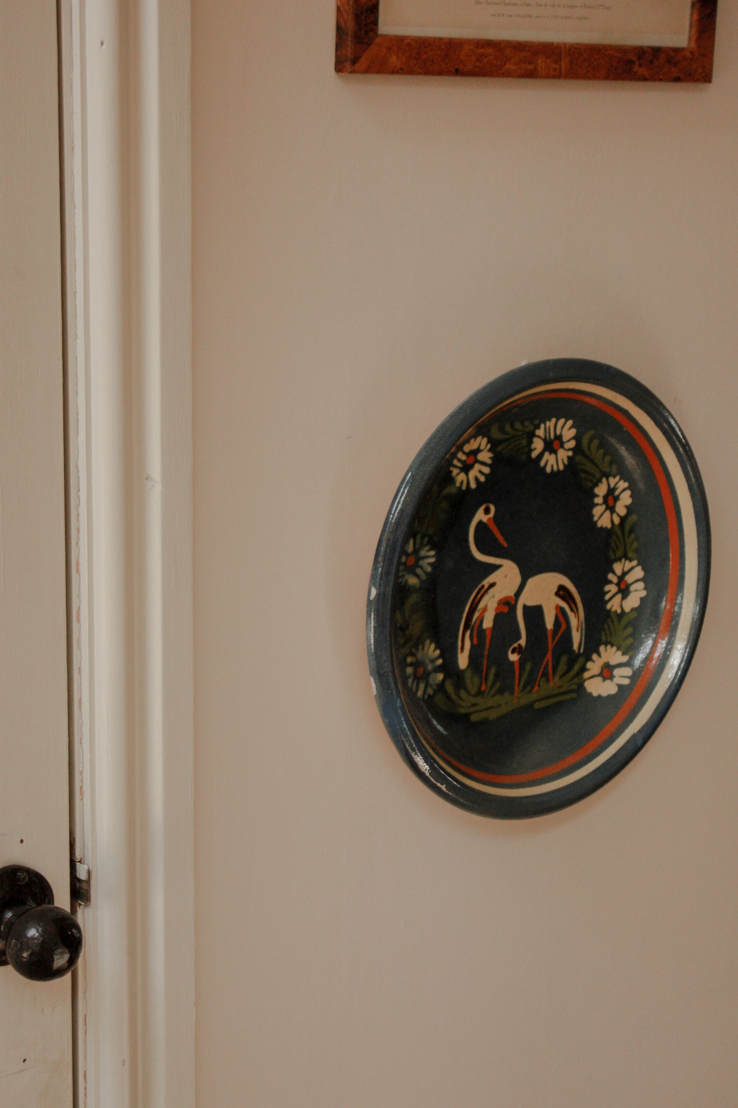 Large art pottery slipware wall plate - storks and flowers