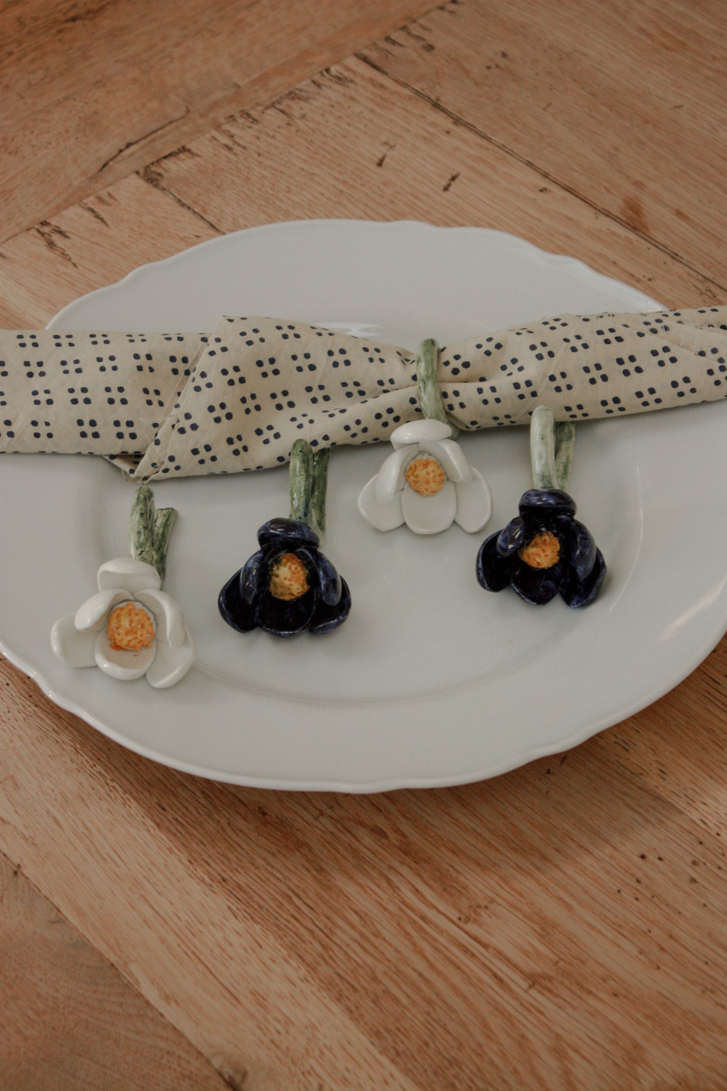 Set of four folk art pottery flower napkin rings