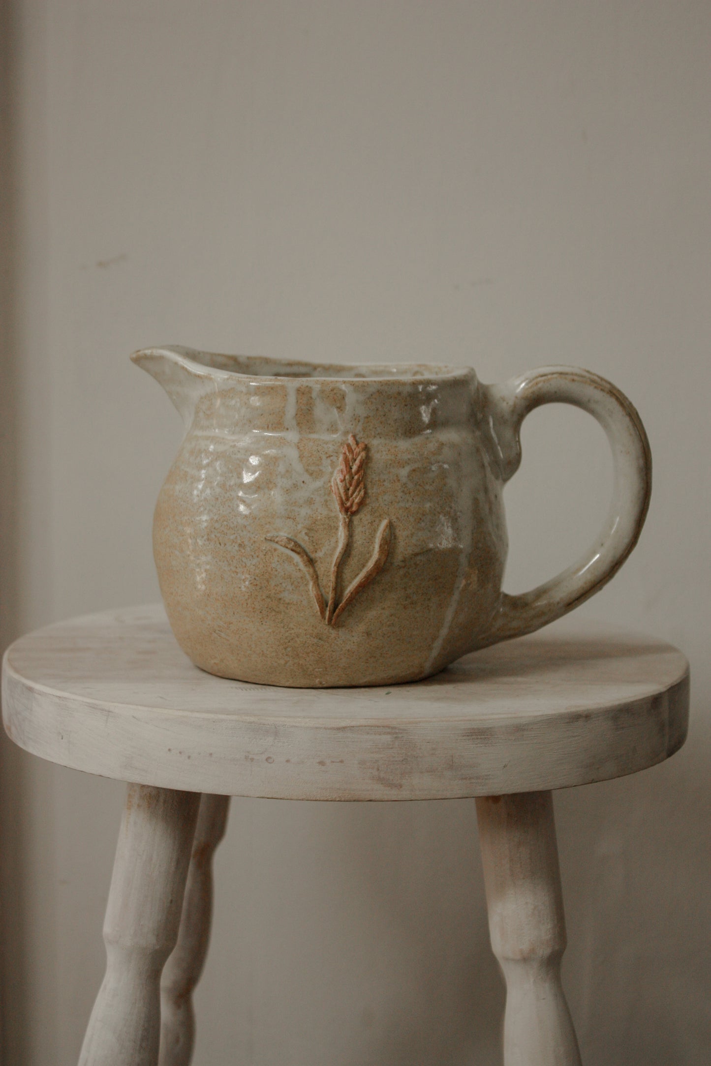 Vintage studio pottery pitcher with wheat design