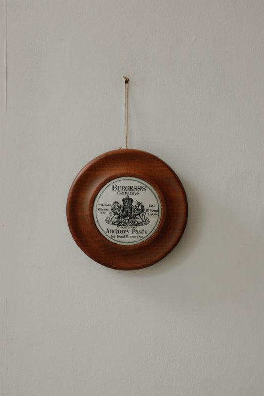 Vintage paste pot lid set in wooden frame