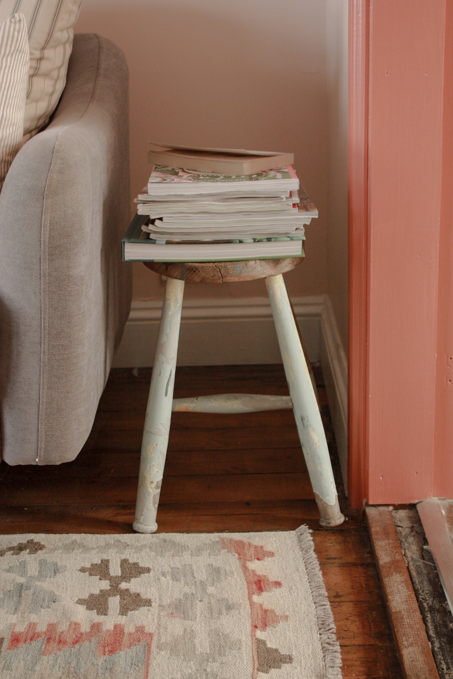 Vintage wooden stool with chippy blue painted legs