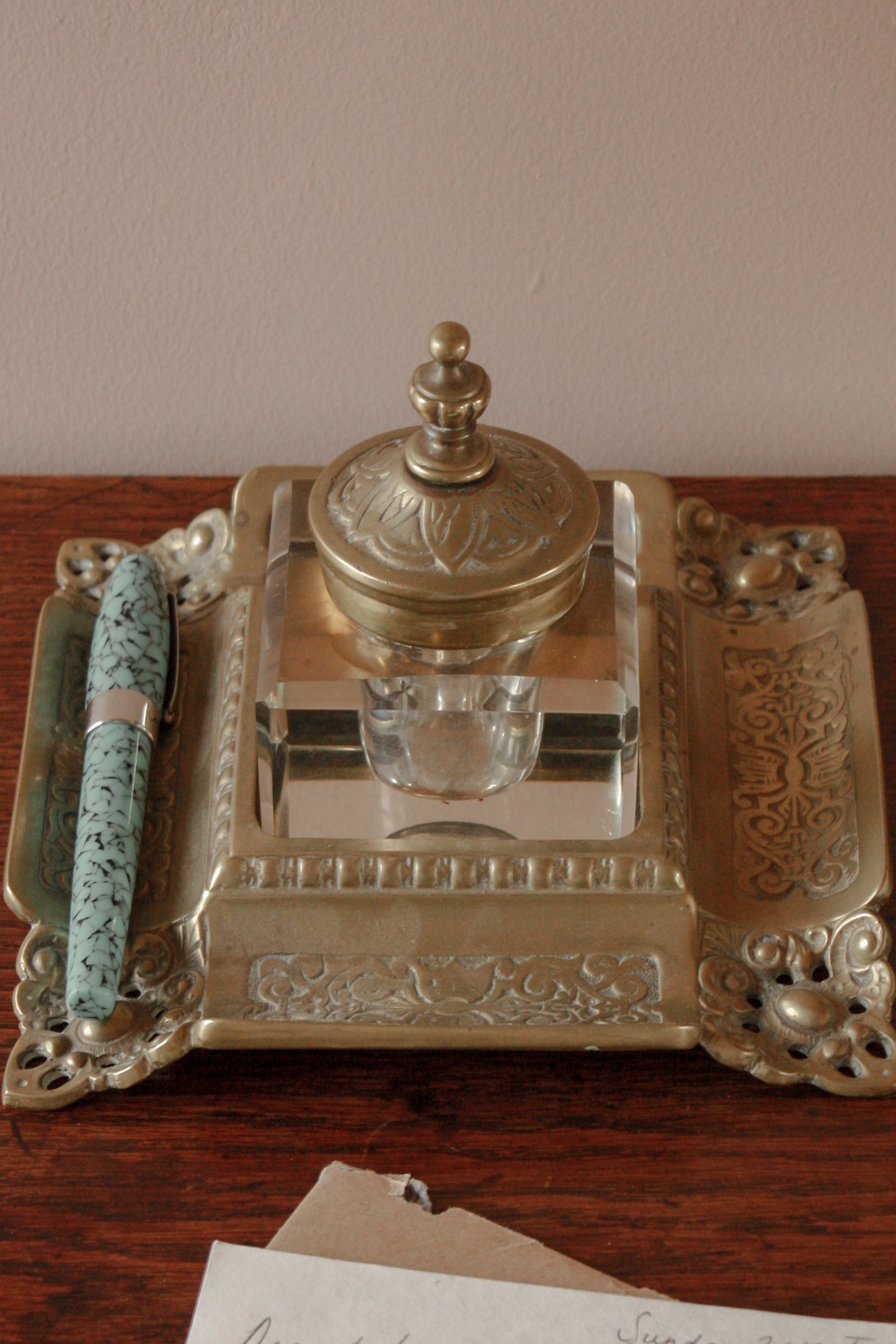 Antique ornate brass ink well with glass ink bottle