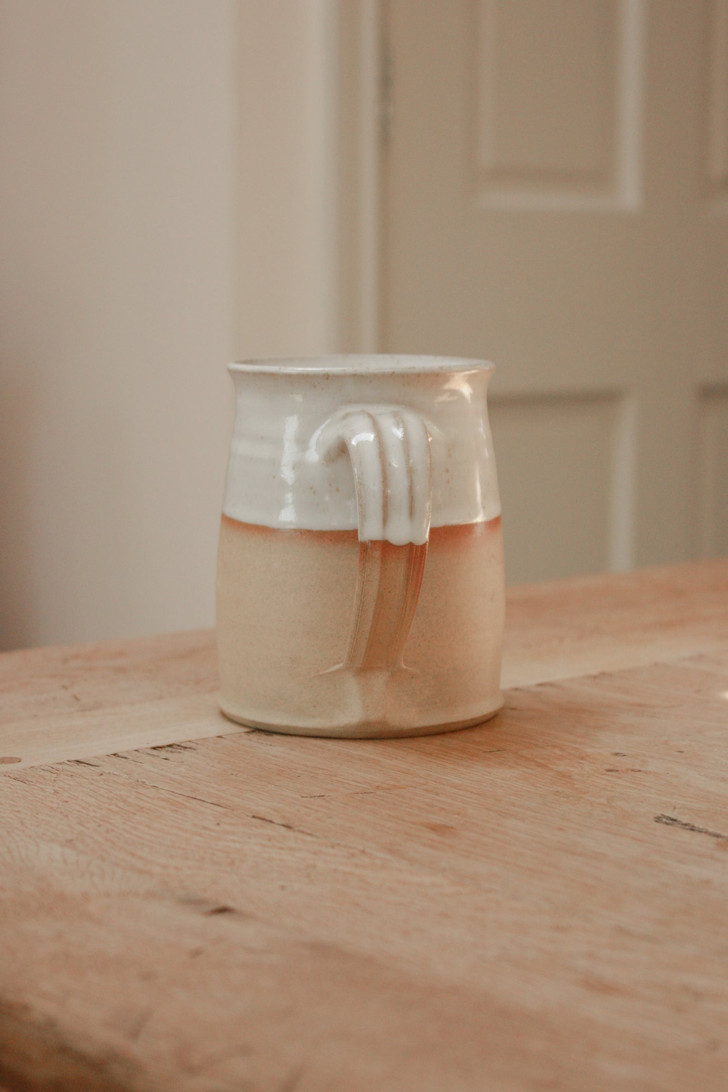 Studio pottery clay mug with rustic two tone glaze