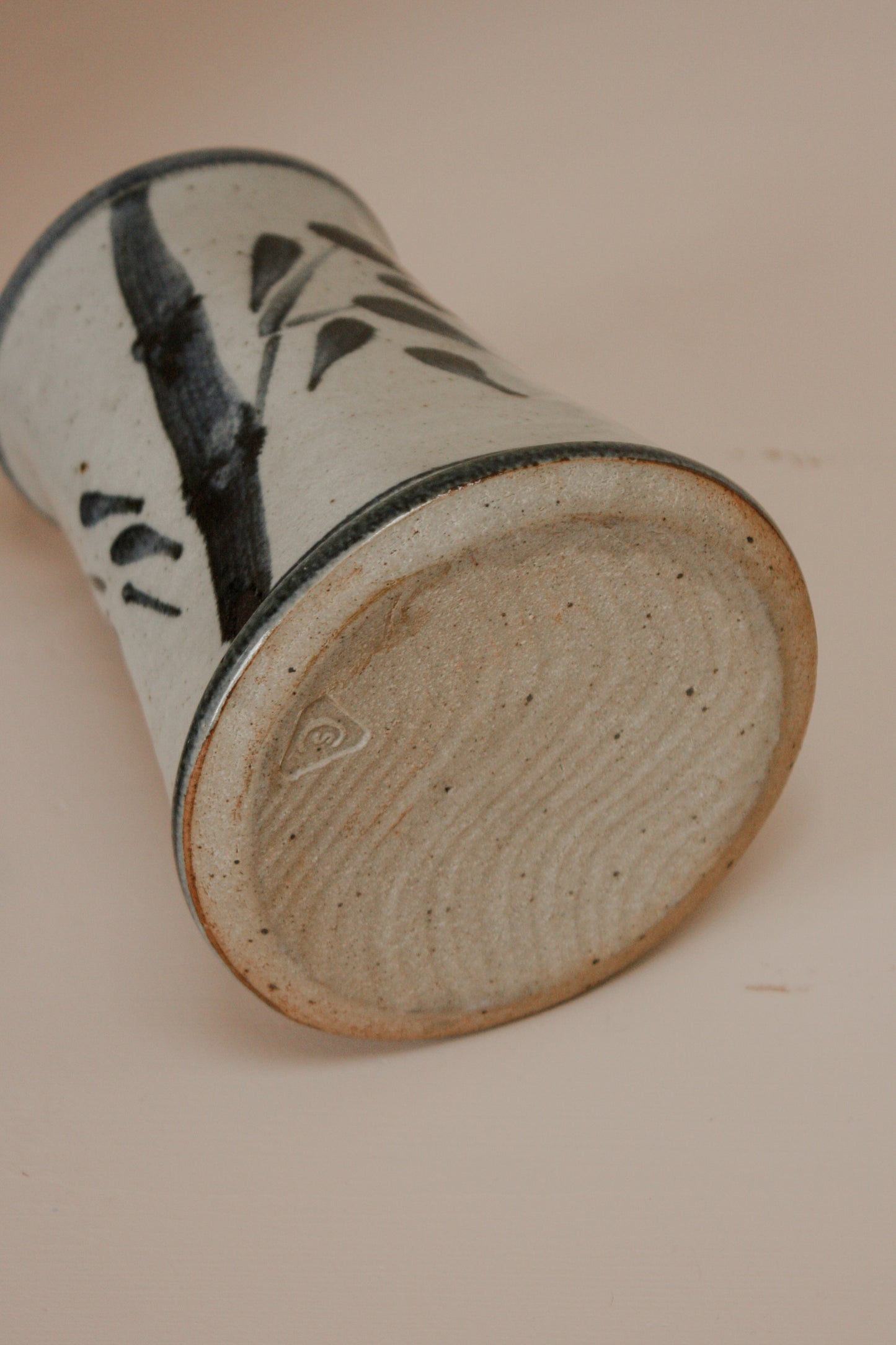 Rustic studio pottery vase with blue foliage details