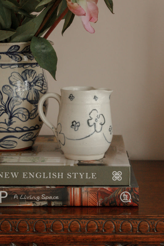 Studio pottery creamer with hand painted floral design
