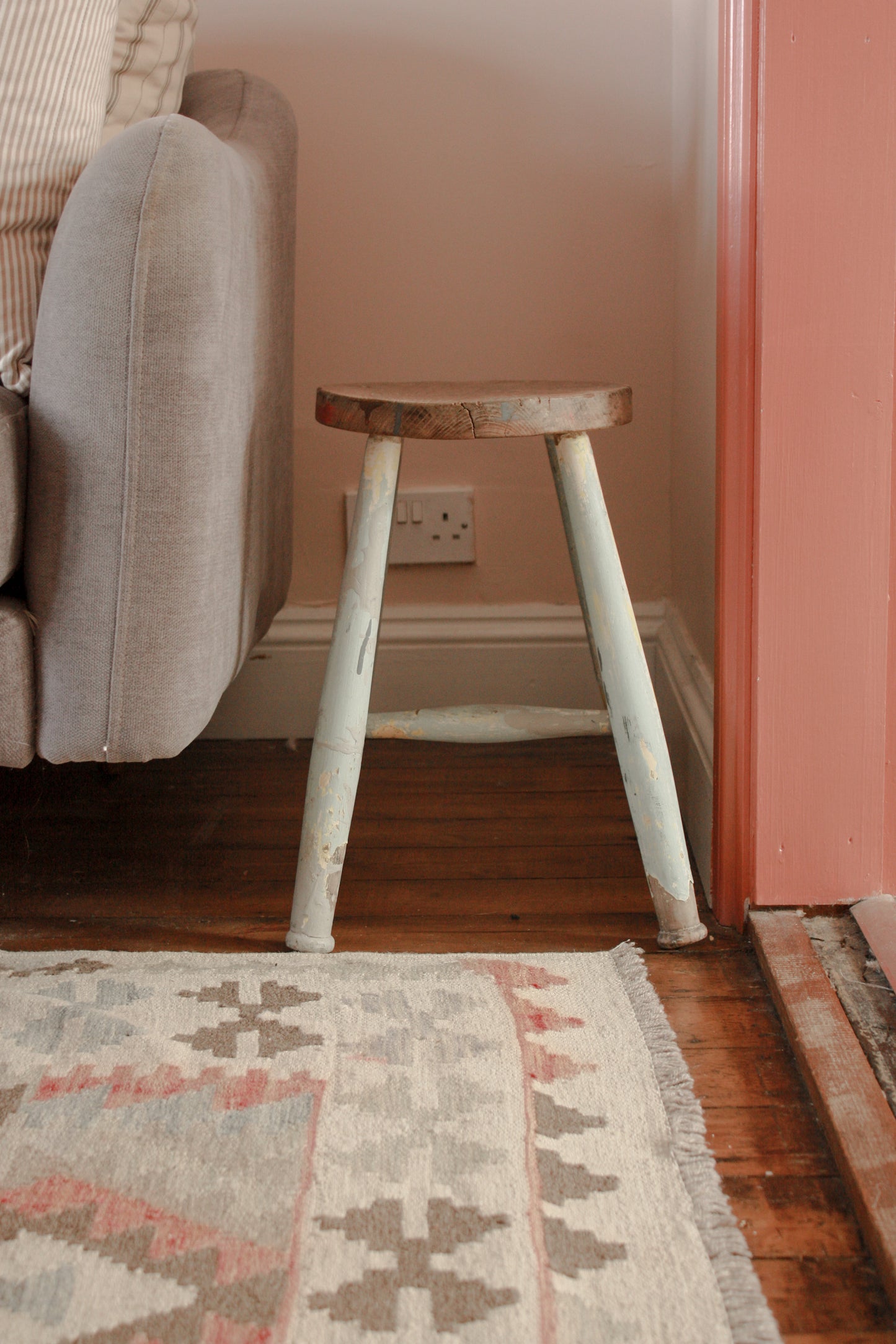 Vintage wooden stool with chippy blue painted legs