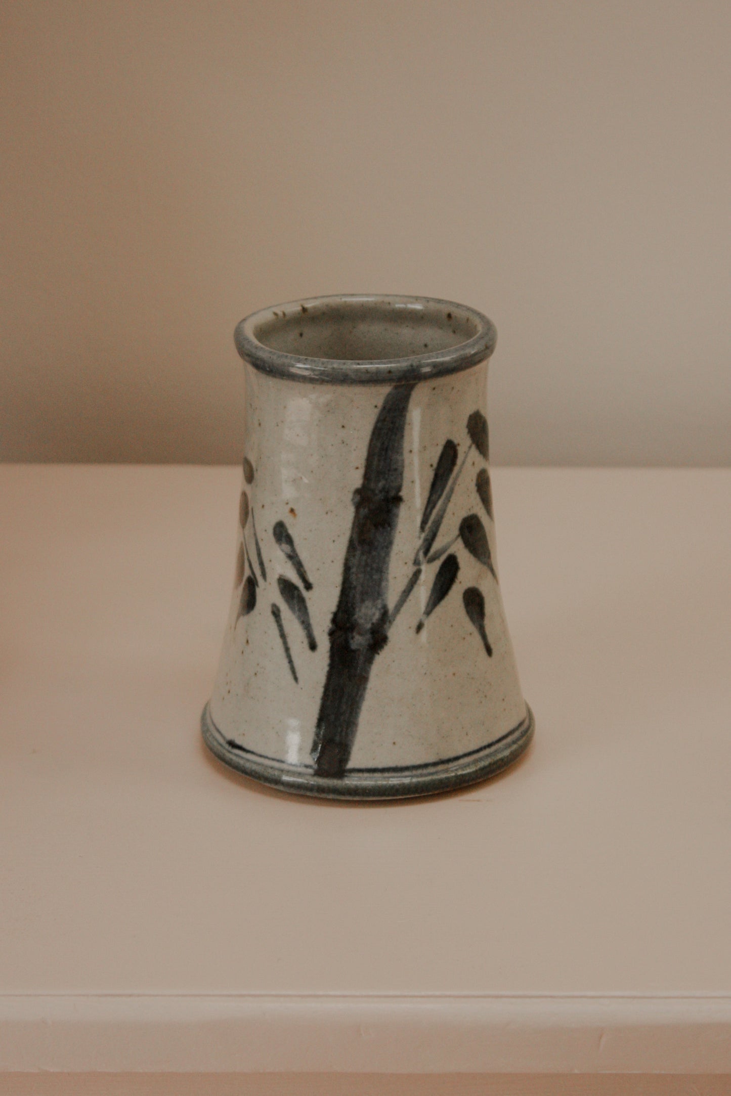 Rustic studio pottery vase with blue foliage details