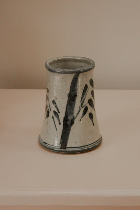 Rustic studio pottery vase with blue foliage details
