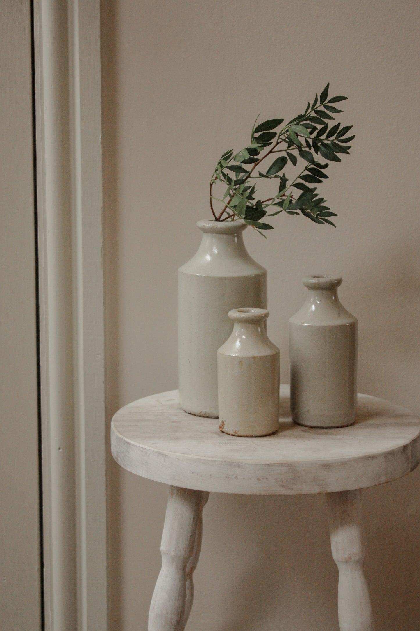 Vintage set of three pale stoneware bottles