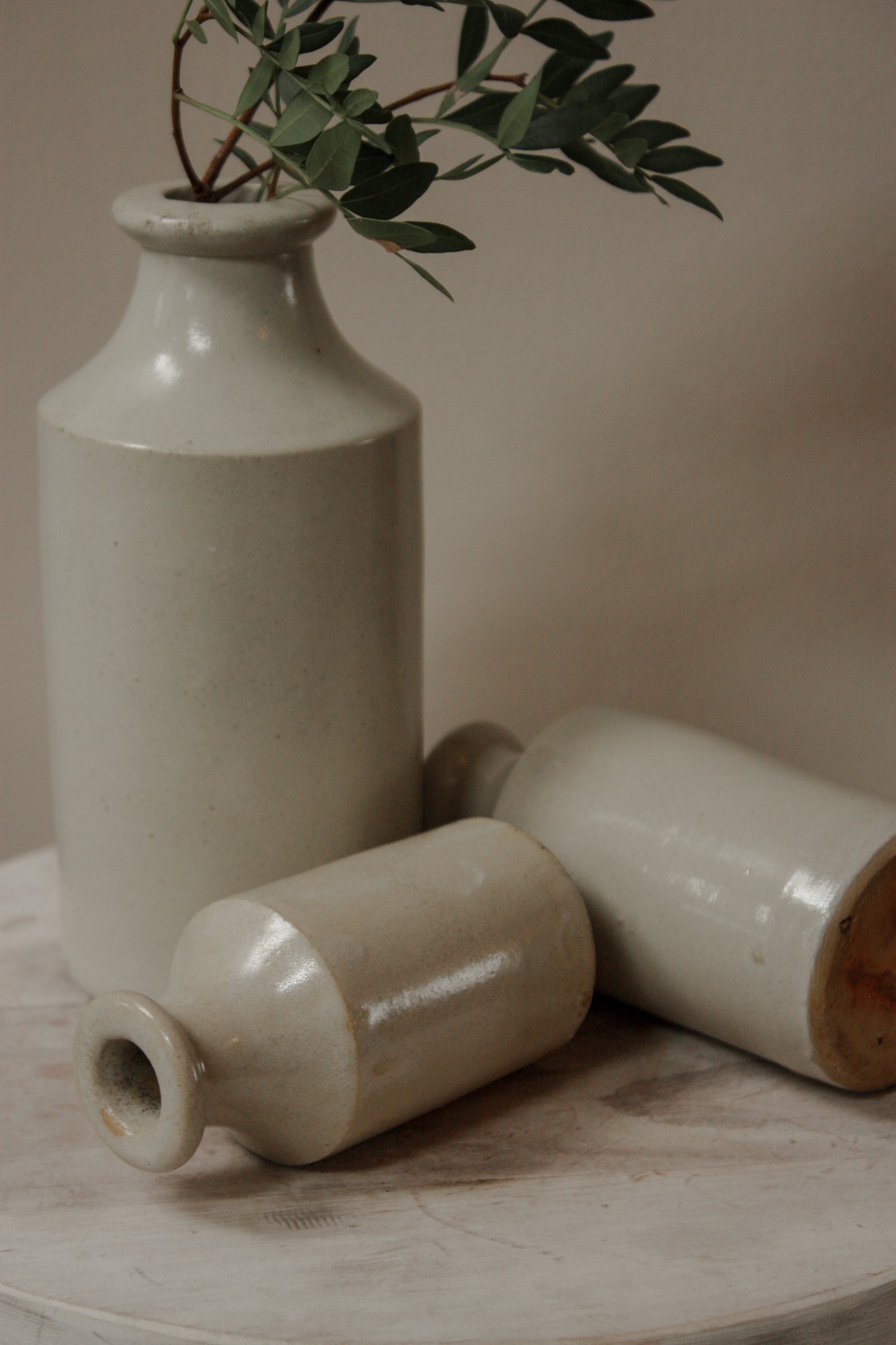 Vintage set of three pale stoneware bottles