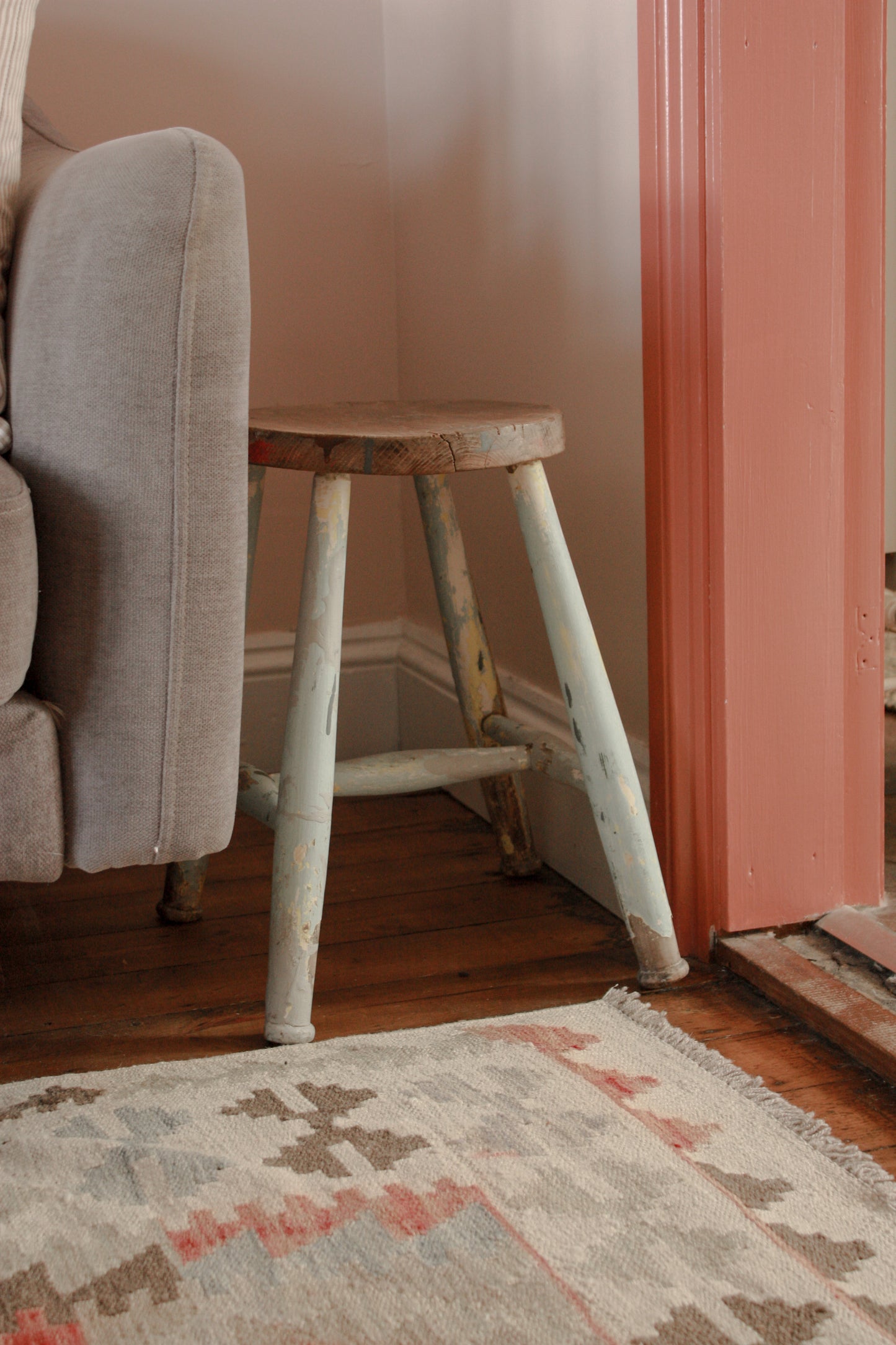 Vintage wooden stool with chippy blue painted legs
