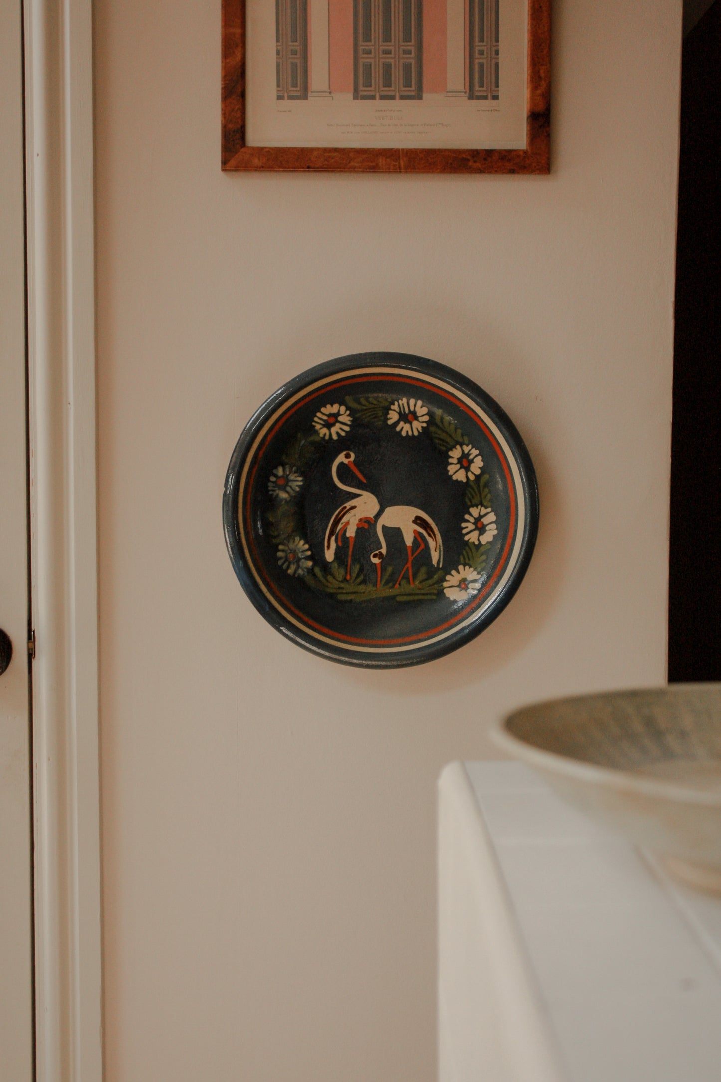 Large art pottery slipware wall plate - storks and flowers
