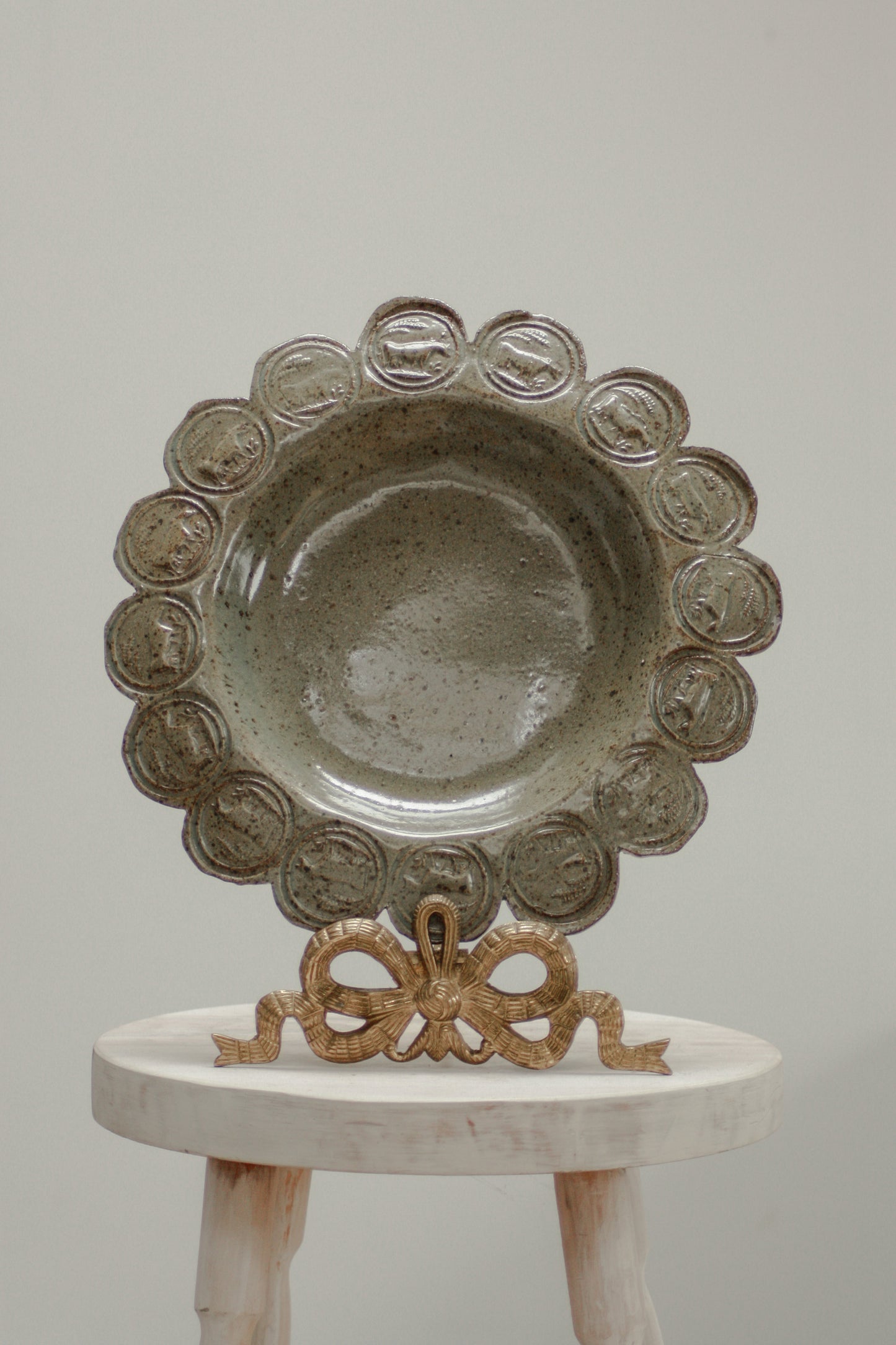 Vintage studio pottery dish with cow stamp motif