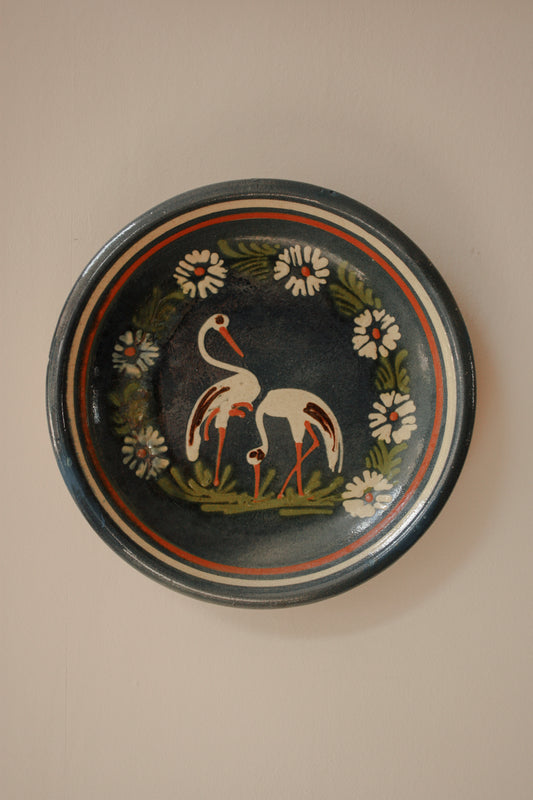 Large art pottery slipware wall plate - storks and flowers