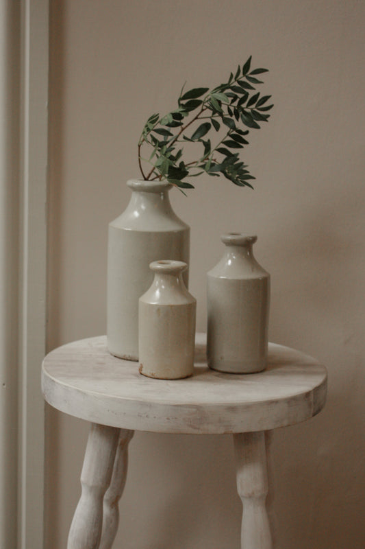 Vintage set of three pale stoneware bottles
