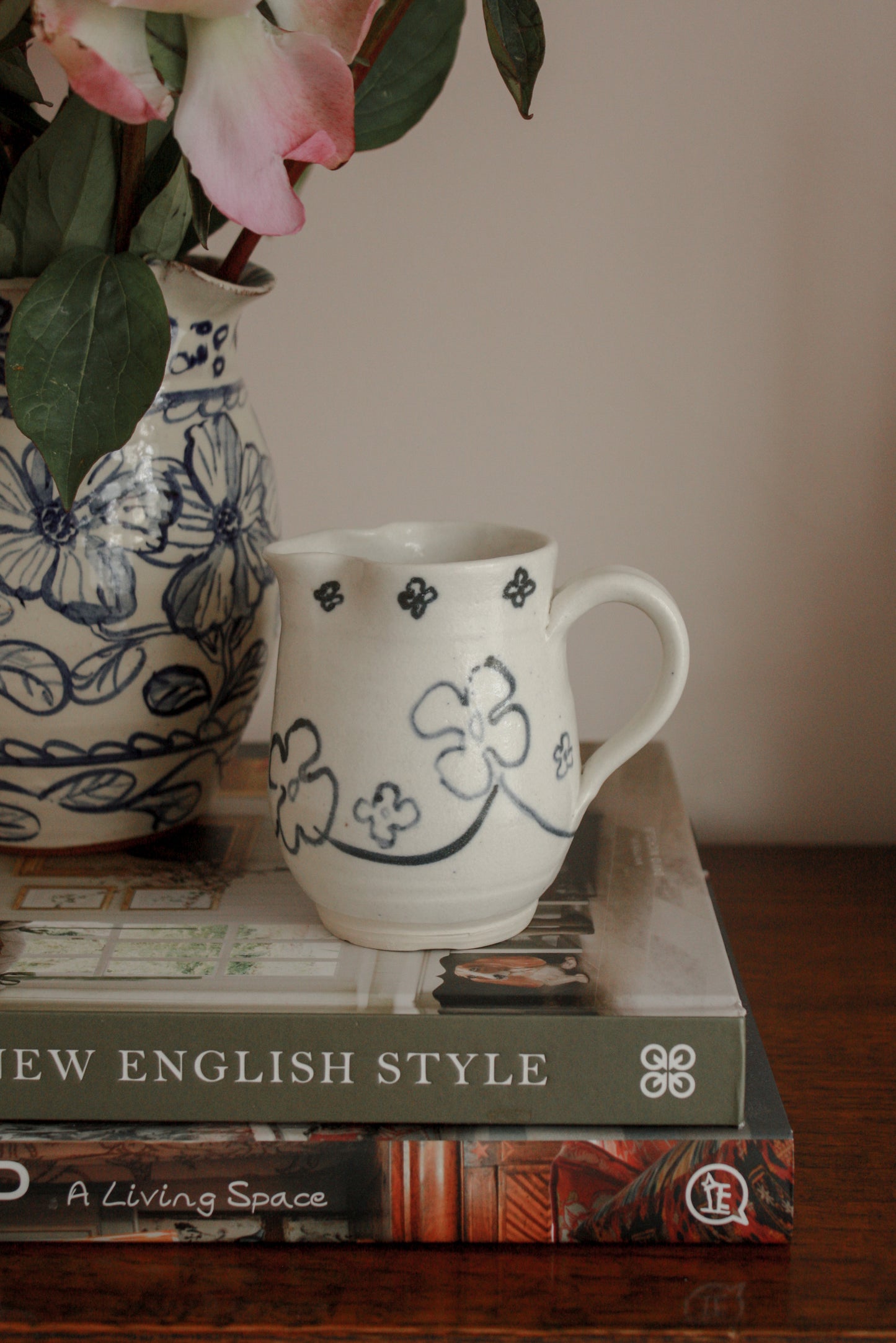 Studio pottery creamer with hand painted floral design