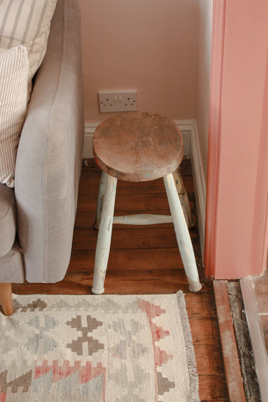 Vintage wooden stool with chippy blue painted legs