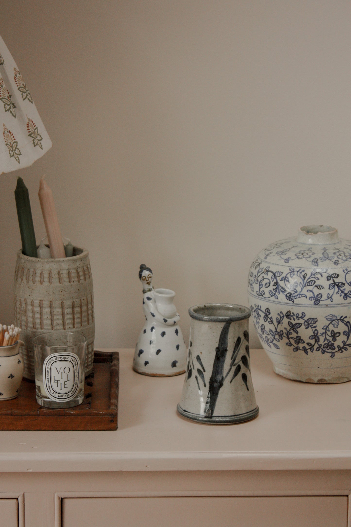 Rustic studio pottery vase with blue foliage details