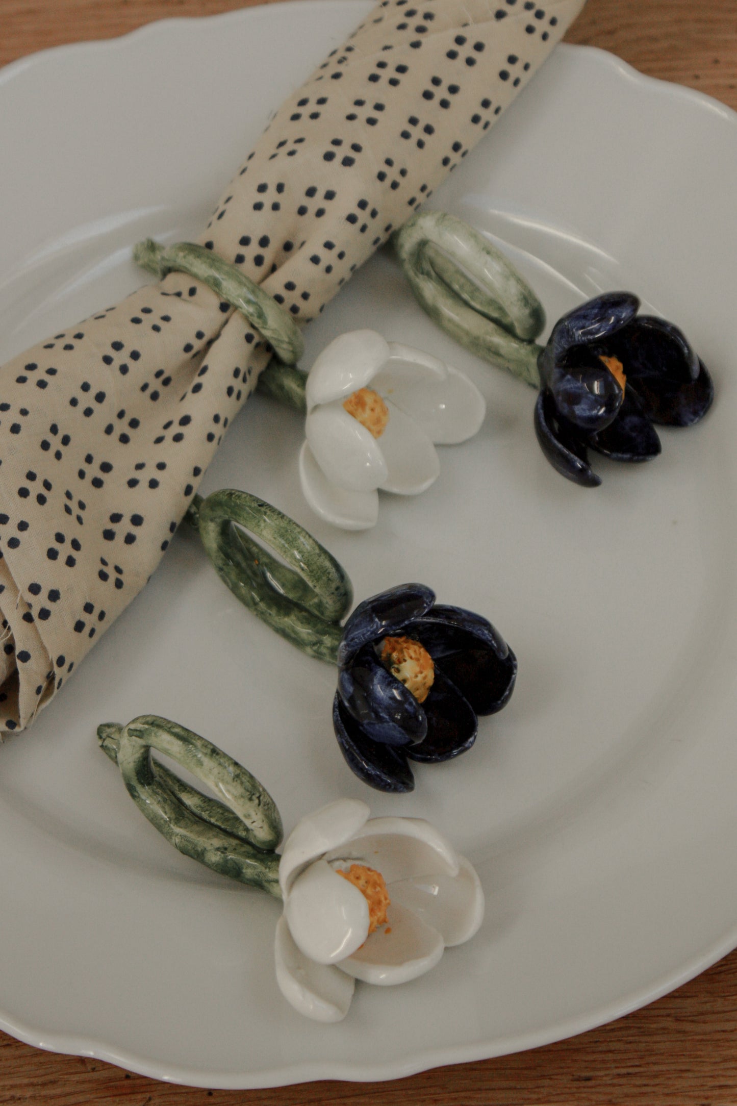 Set of four folk art pottery flower napkin rings
