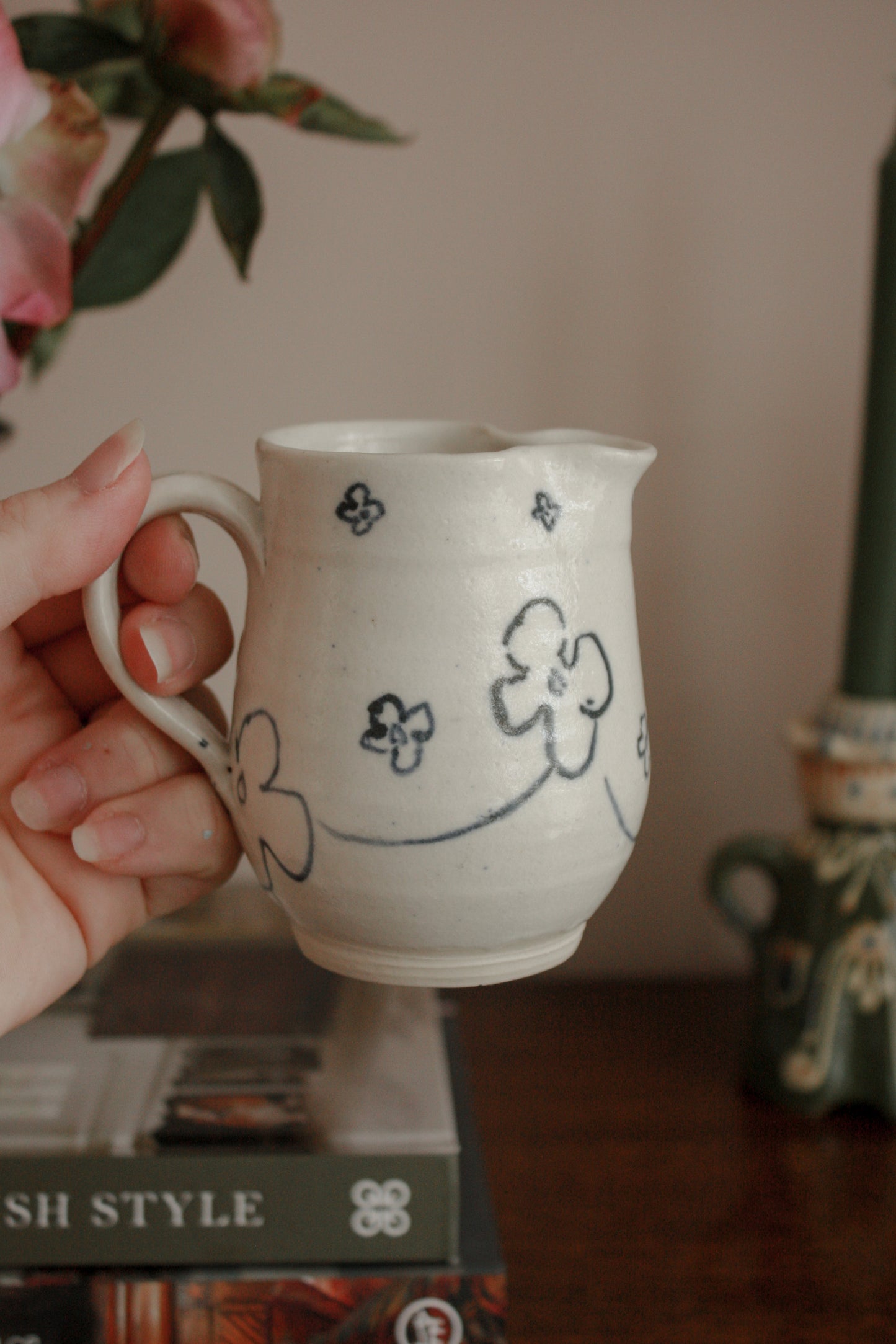 Studio pottery creamer with hand painted floral design